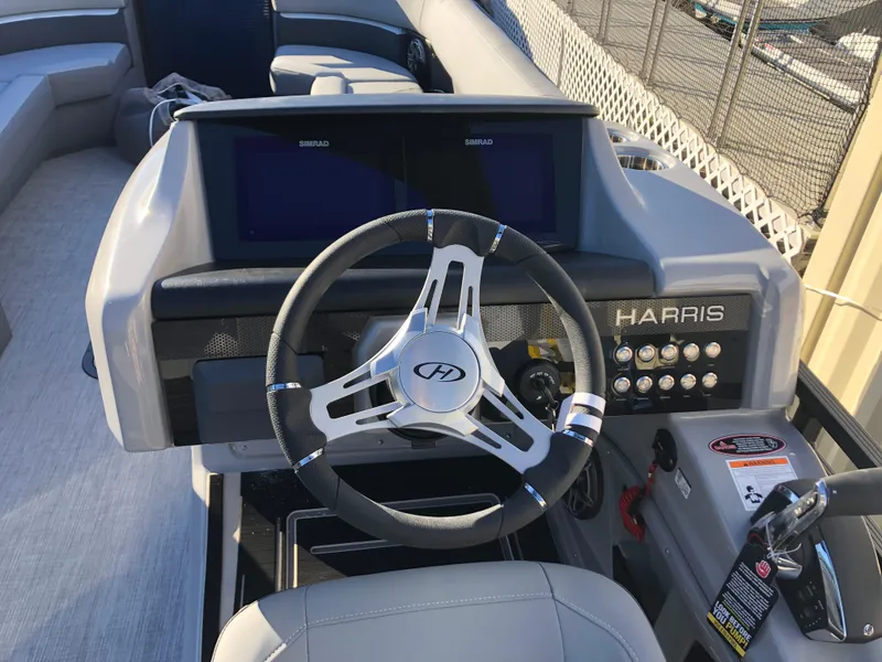 Slide: The Image of 2023 Harris Solstice 250 boat dashboard with steering wheel and controls. - 10