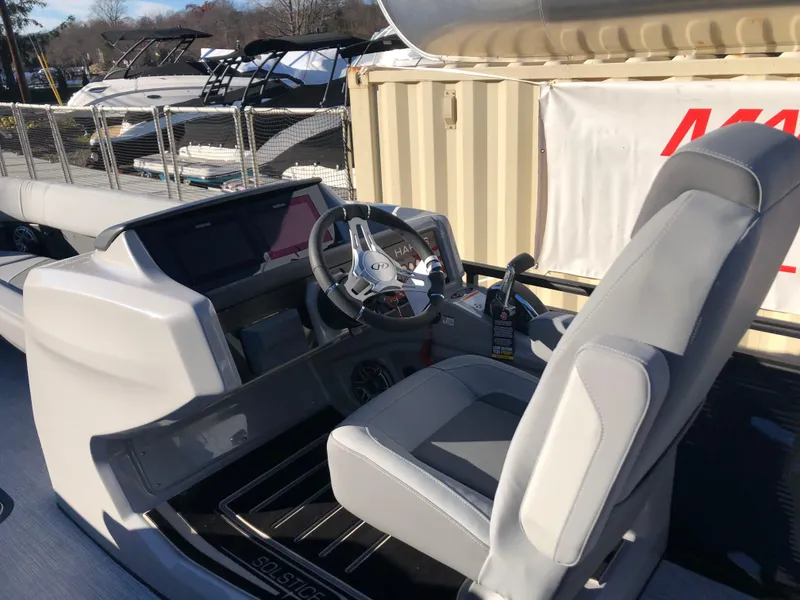 Slide: The Image of 2023 Harris Solstice 250 boat interior with steering wheel and dashboard. - 11