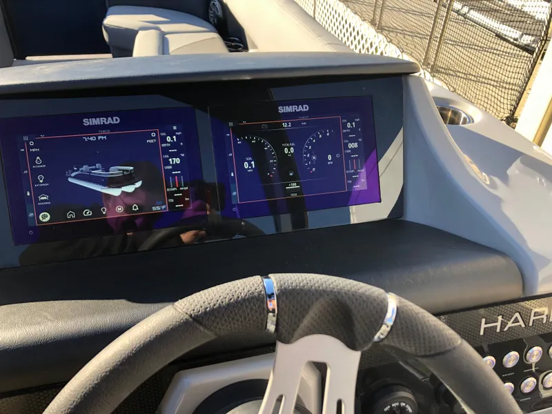 Slide: The Image of Dashboard of 2023 Harris Solstice 250 boat with Simrad displays. - 13