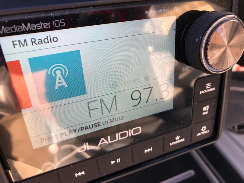 Slide: The Image of JL Audio MediaMaster 105 displaying FM radio 97.3 in a 2023 Harris Solstice 250. - 19