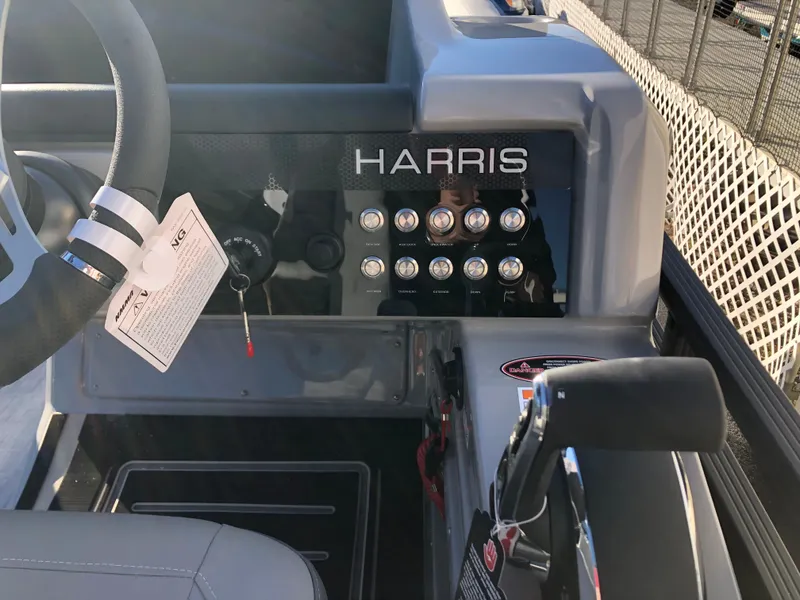 Slide: The Image of 2023 Harris Solstice 250 boat dashboard with steering wheel and control panel. - 20