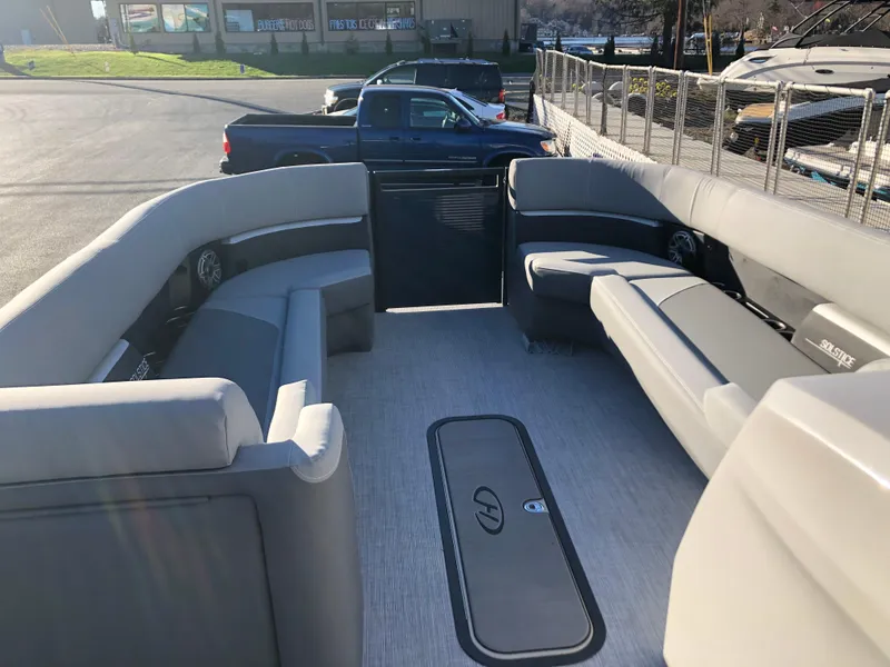 Slide: The Image of 2023 Harris Solstice 250 pontoon boat interior with spacious seating and modern design. - 21