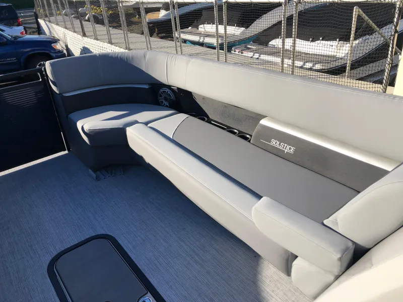 Slide: The Image of 2023 Harris Solstice 250 boat interior with gray seating and cup holders. - 24