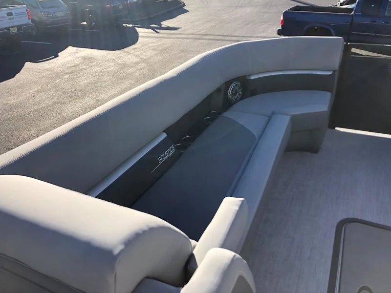 Slide: The Image of 2023 Harris Solstice 250 boat interior with gray seating and cup holders. - 25