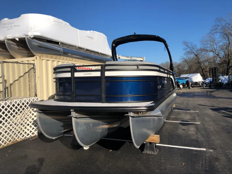 Slide: The Image of 2023 Harris Solstice 250 pontoon boat on display in a marina. - 3