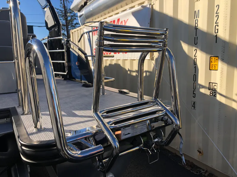 Slide: The Image of 2023 Harris Solstice 250 boat with shiny stainless steel ladder. - 32