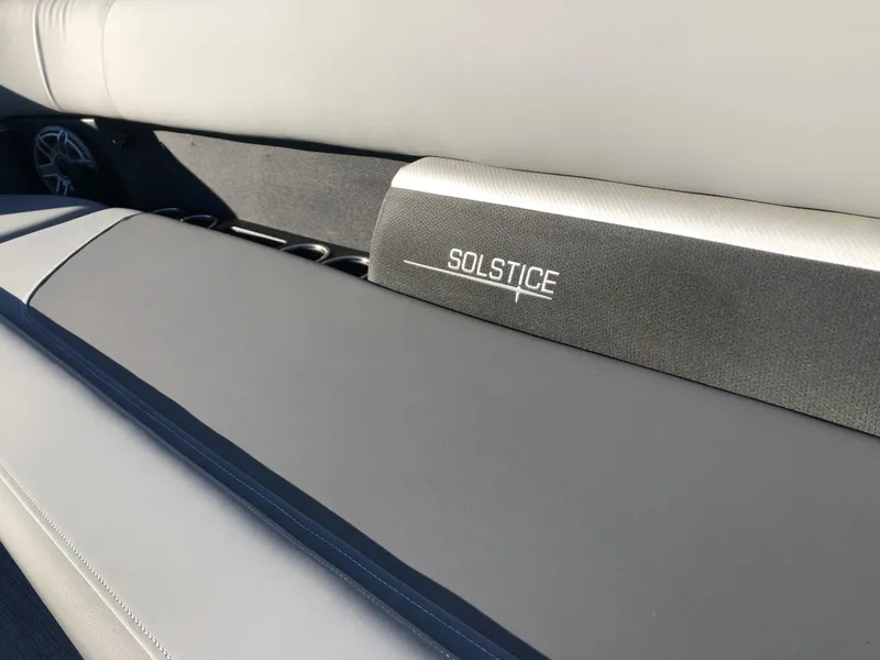 Slide: The Image of 2023 Harris Solstice 250 boat interior with sleek seating and logo detail. - 34