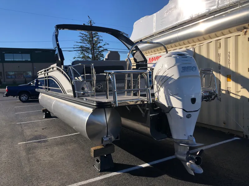 Slide: The Image of 2023 Harris Solstice 250 pontoon boat with Mercury 350 engine in parking lot. - 5