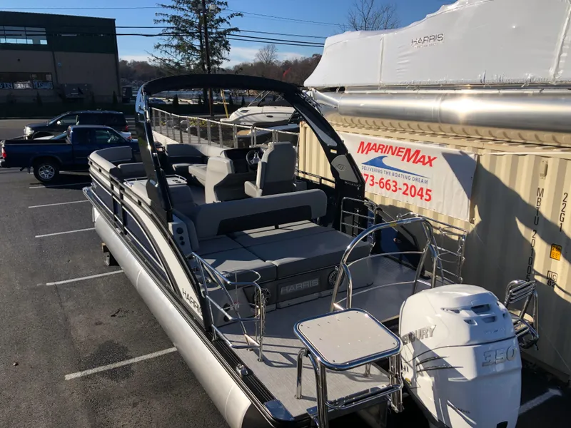 Slide: The Image of 2023 Harris Solstice 250 pontoon boat in parking lot, featuring Mercury 350 engine. - 7