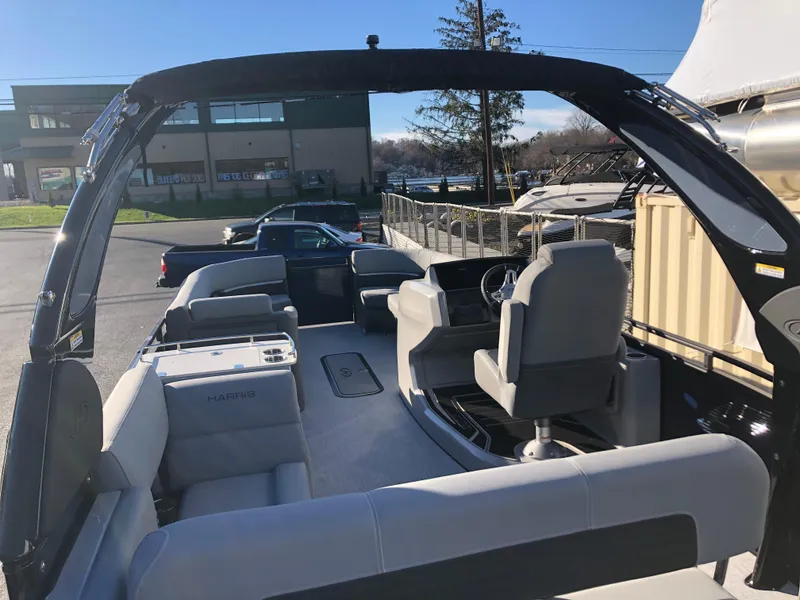 Slide: The Image of 2023 Harris Solstice 250 pontoon boat interior with seating and helm. - 8