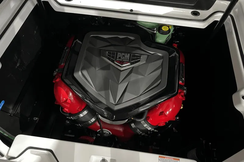 Slide: The Image of 2023 Nautique Super Air Nautique S25 engine with PCM cover, red components. - 10
