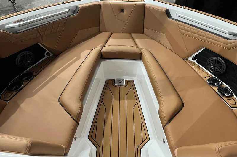 Slide: The Image of Luxurious interior of 2023 Nautique Super Air Nautique S25 boat with tan seating. - 11