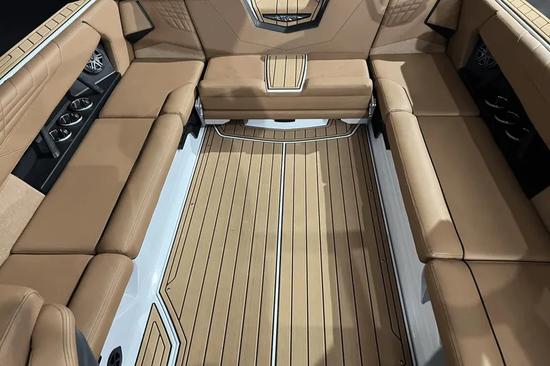 Slide: The Image of Luxurious interior of 2023 Nautique Super Air Nautique S25 boat with tan seating. - 12