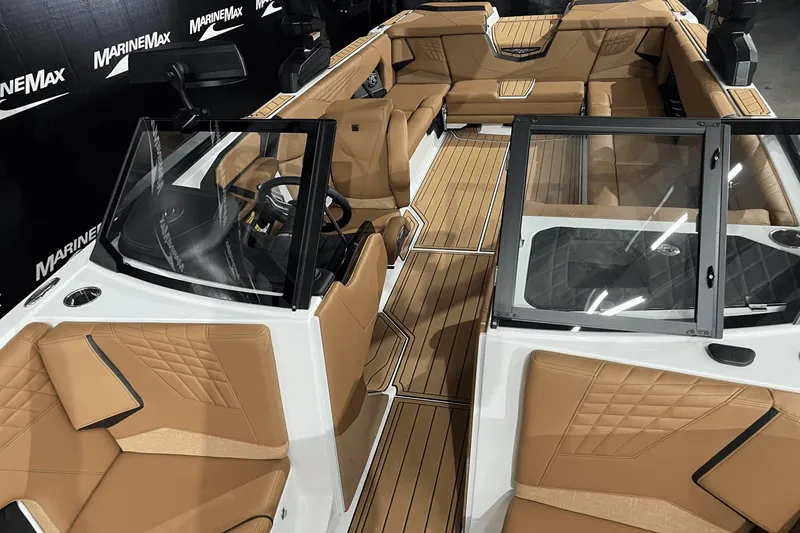Slide: The Image of 2023 Nautique Super Air Nautique S25 interior with tan leather seating and sleek design. - 13