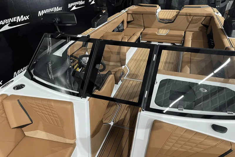 Slide: The Image of 2023 Nautique Super Air Nautique S25 interior with tan leather seating and sleek design. - 14