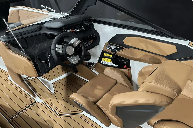 Slide: The Image of 2023 Nautique Super Air Nautique S25 interior with tan leather seats and modern dashboard. - 15
