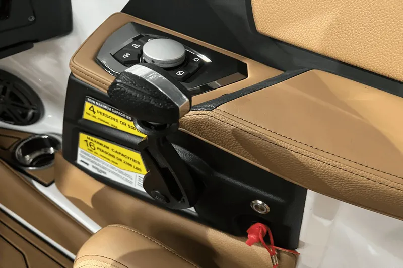 Slide: The Image of 2023 Nautique Super Air Nautique S25 throttle control and seating detail. - 16