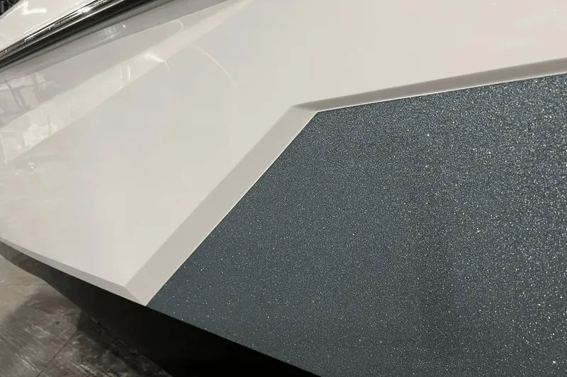 Slide: The Image of Close-up of 2023 Nautique Super Air Nautique S25 boat's sleek, textured exterior design. - 3
