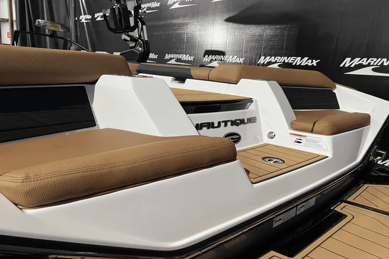 Slide: The Image of 2023 Nautique Super Air Nautique S25 boat with tan seating and sleek design. - 5