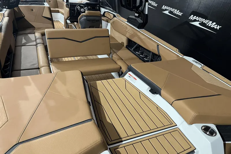 Slide: The Image of 2023 Nautique Super Air Nautique S25 interior with tan upholstery and sleek design. - 8