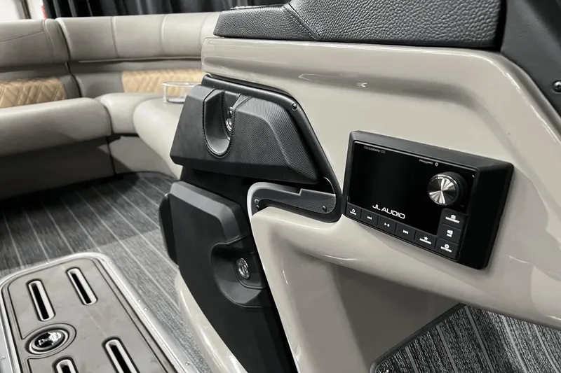 Slide: The Image of 2024 Premier 230 Intrigue interior with JL Audio system and luxurious seating. - 17