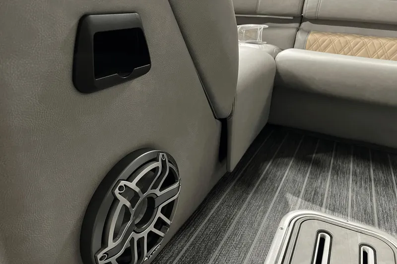 Slide: The Image of 2024 Premier 230 Intrigue interior with speaker and luxurious seating details. - 22