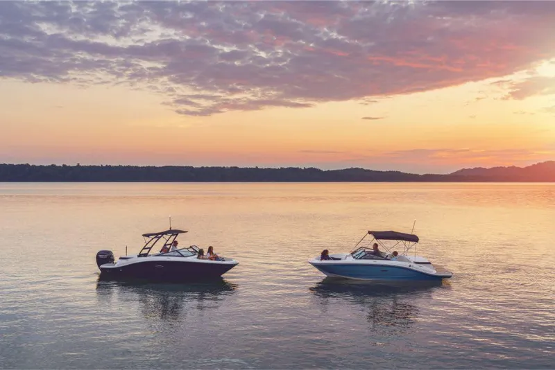 Slide: The Image of Two Sea Ray SPX 190 boats on a serene lake at sunset, 2020 model. - 11