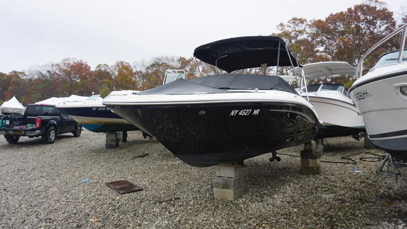 Slide: The Image of 2020 Sea Ray SPX 190 boat on blocks in a gravel lot. - 2