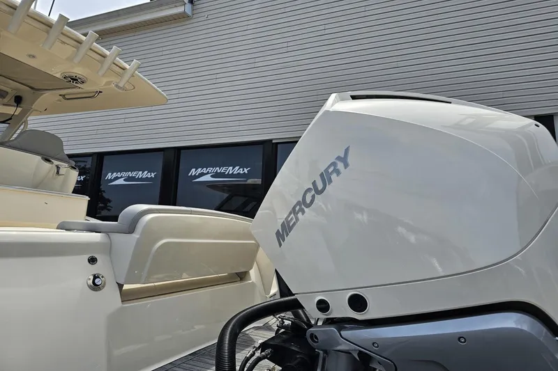 Slide: The Image of 2024 Scout 305 LXF boat with Mercury engine at MarineMax dealership. - 11