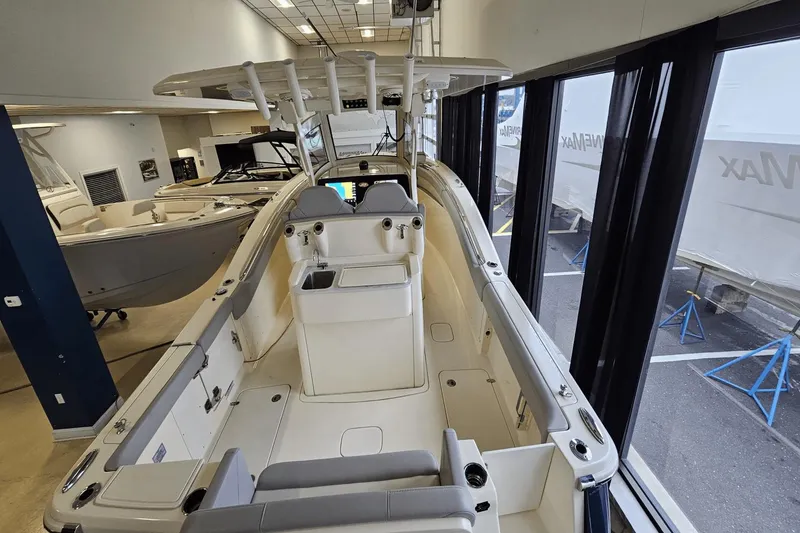 Slide: The Image of 2024 Scout 305 LXF boat interior in showroom, featuring sleek design and modern amenities. - 14