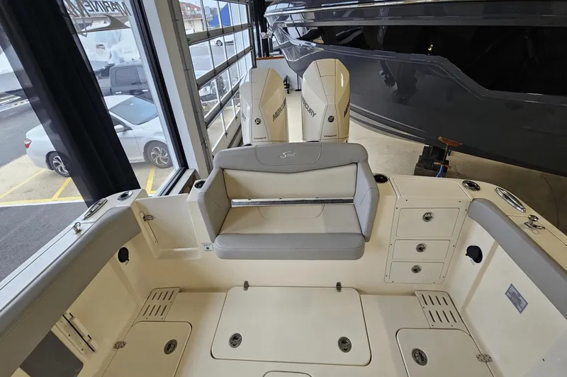 Slide: The Image of 2024 Scout 305 LXF boat interior with seating and storage compartments. - 15