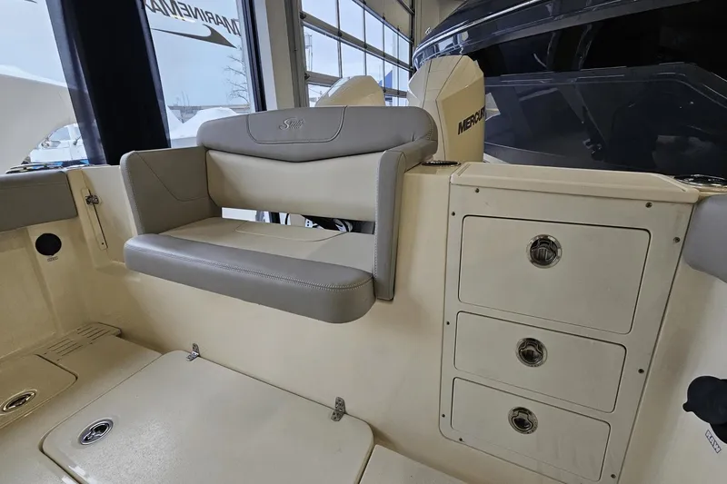 Slide: The Image of 2024 Scout 305 LXF boat interior with seating and storage compartments. - 16