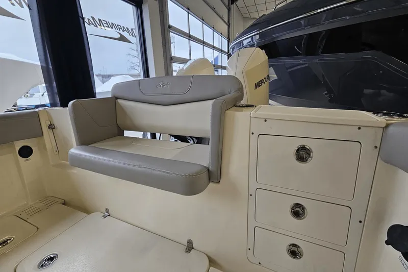 Slide: The Image of 2024 Scout 305 LXF boat interior with seating and storage compartments. - 17