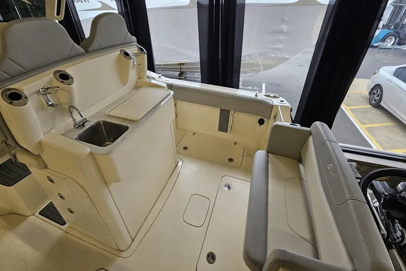 Slide: The Image of 2024 Scout 305 LXF boat interior with sink, seating, and storage area. - 18