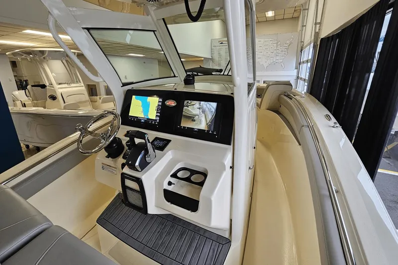 Slide: The Image of 2024 Scout 305 LXF boat interior with modern dashboard and navigation screens. - 20