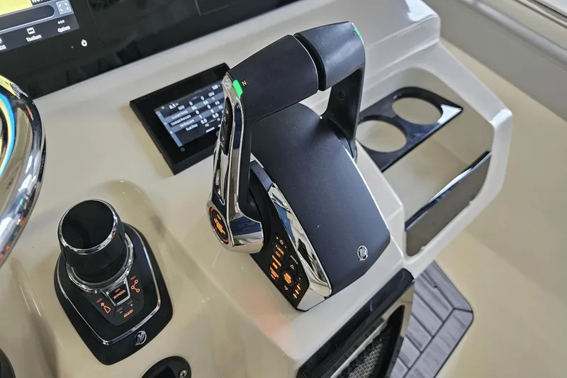 Slide: The Image of Control panel of 2024 Scout 305 LXF boat with modern throttle and joystick. - 22