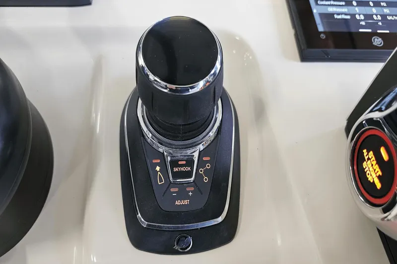 Slide: The Image of 2024 Scout 305 LXF boat control panel with joystick and Skyhook feature. - 23