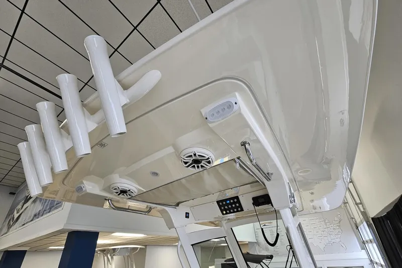 Slide: The Image of 2024 Scout 305 LXF boat interior with rod holders and speakers. - 24