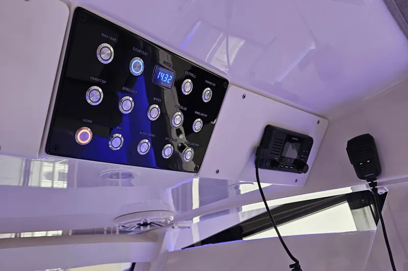 Slide: The Image of Control panel of 2024 Scout 305 LXF boat with illuminated buttons and display. - 25