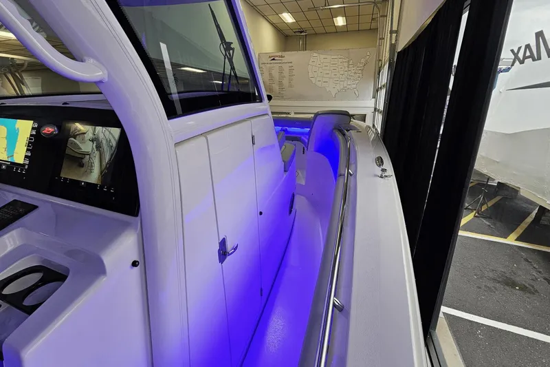 Slide: The Image of 2024 Scout 305 LXF boat interior with blue LED lighting and navigation displays. - 28