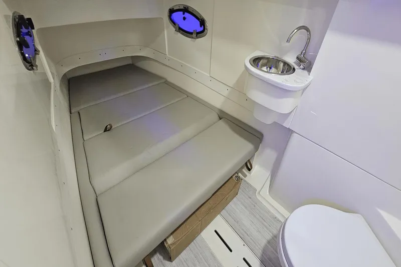 Slide: The Image of 2024 Scout 305 LXF cabin interior with bed, sink, and toilet. - 30