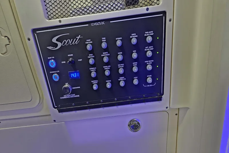 Slide: The Image of 2024 Scout 305 LXF control panel with various switches and digital display. - 31