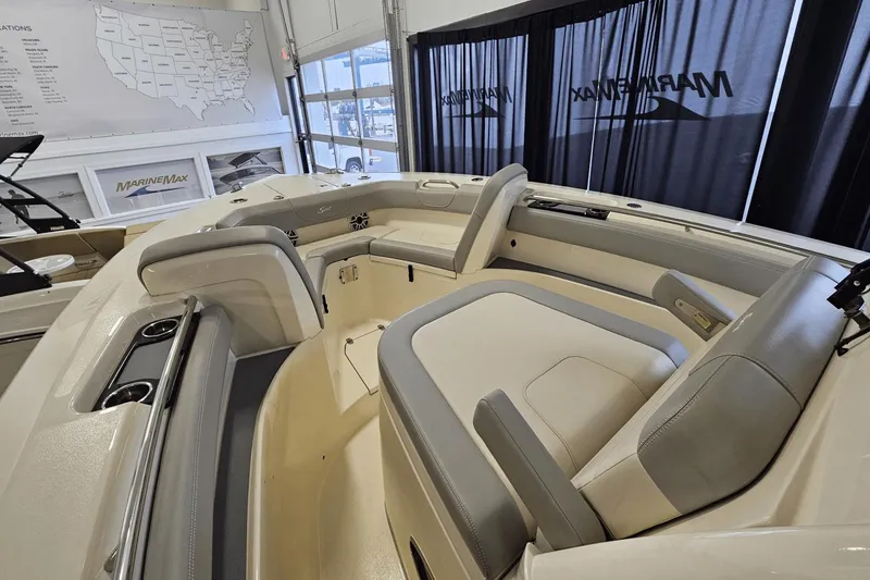 Slide: The Image of 2024 Scout 305 LXF boat interior with luxurious seating and cup holders. - 32