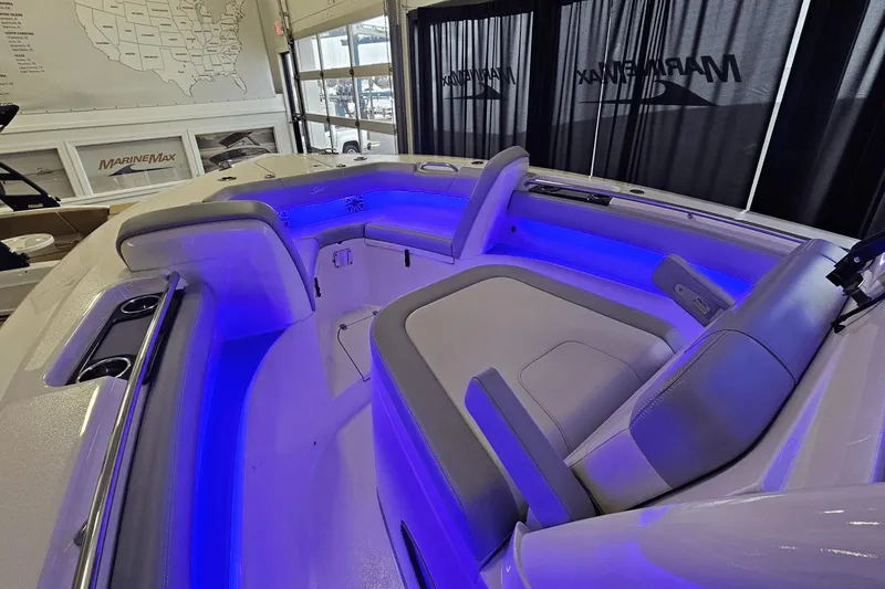 Slide: The Image of 2024 Scout 305 LXF boat interior with blue LED lighting and comfortable seating. - 33