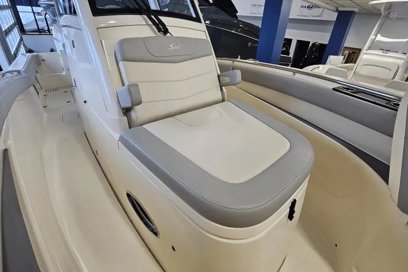 Slide: The Image of 2024 Scout 305 LXF boat interior with cushioned seating and sleek design. - 34