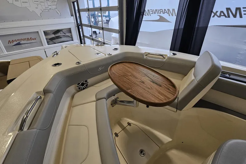 Slide: The Image of 2024 Scout 305 LXF boat interior with seating and wooden table. - 37