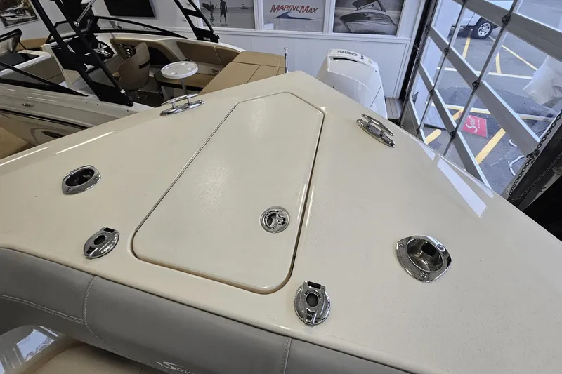 Slide: The Image of 2024 Scout 305 LXF boat deck with sleek design and chrome fittings. - 38