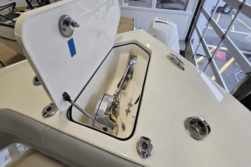 Slide: The Image of 2024 Scout 305 LXF boat anchor compartment with open hatch, showcasing sleek design and functionality. - 39