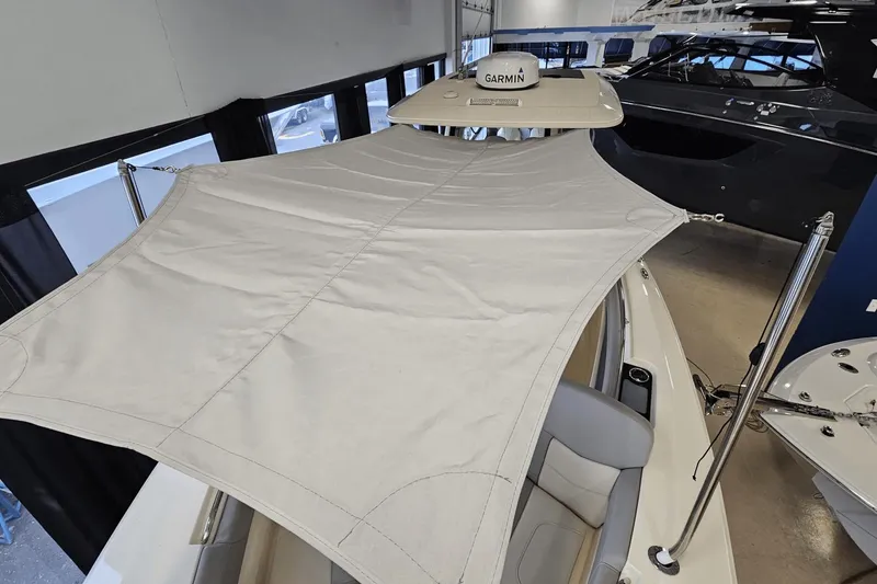 Slide: The Image of 2024 Scout 305 LXF boat with canopy and Garmin equipment in showroom. - 41