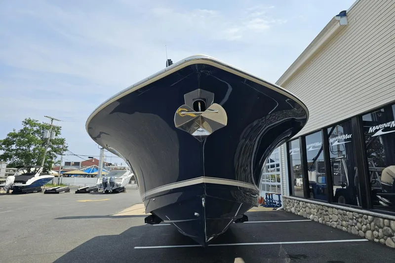 Slide: The Image of 2024 Scout 305 LXF boat displayed at a marina, front view. - 5